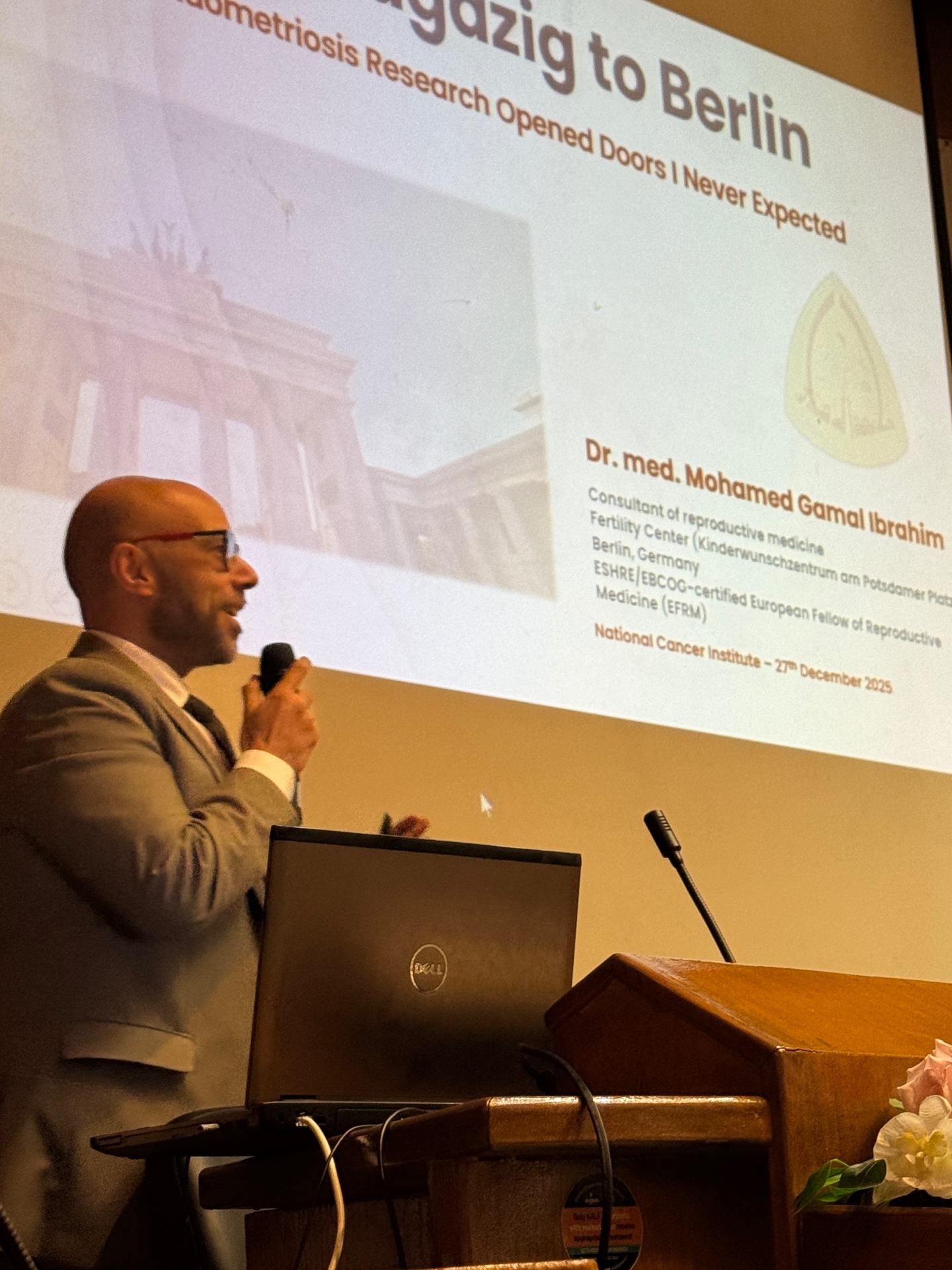 Speaker presenting a research journey from Zagazig to Berlin
